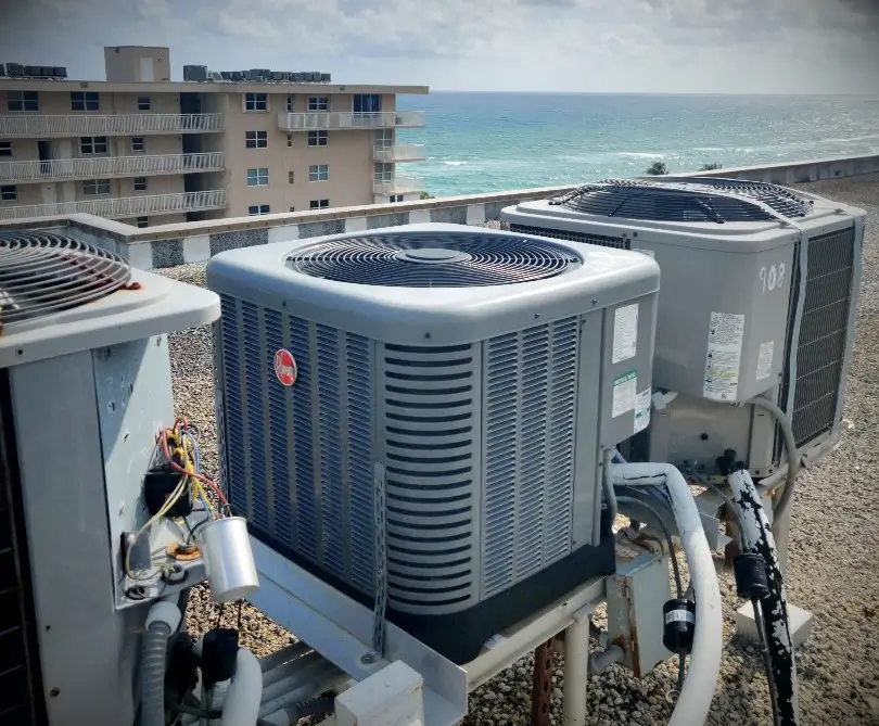 Rheem AC Condenser being repaired on a rooftop.